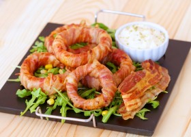 Pikant kolutovi luka zamotani u slaninu